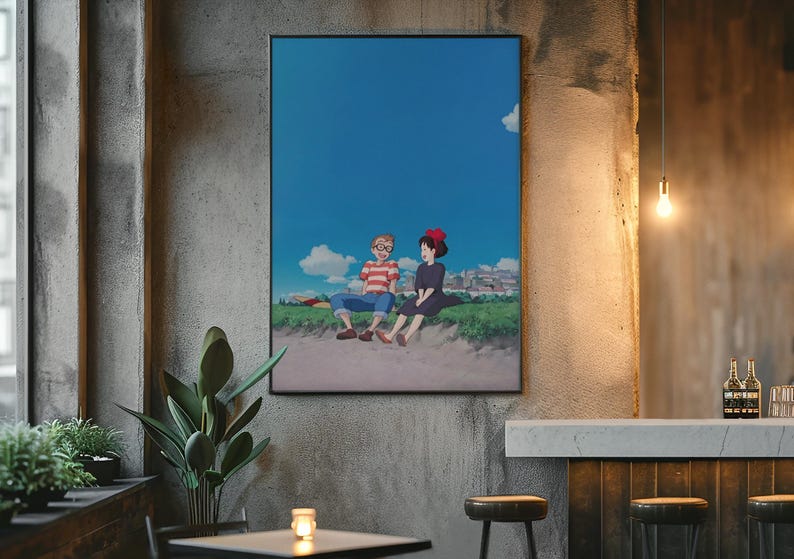 May include: A framed anime art print featuring two characters sitting on a grassy area under a bright blue sky with fluffy white clouds. The artwork is displayed on a textured gray wall.