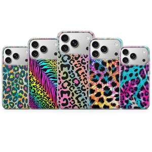 May include: Five smartphone cases arranged in a row, each featuring a distinct animal print pattern in vibrant neon colours including pink, blue, yellow, and green. The cases have a clear top section and a triple camera cutout on the back.