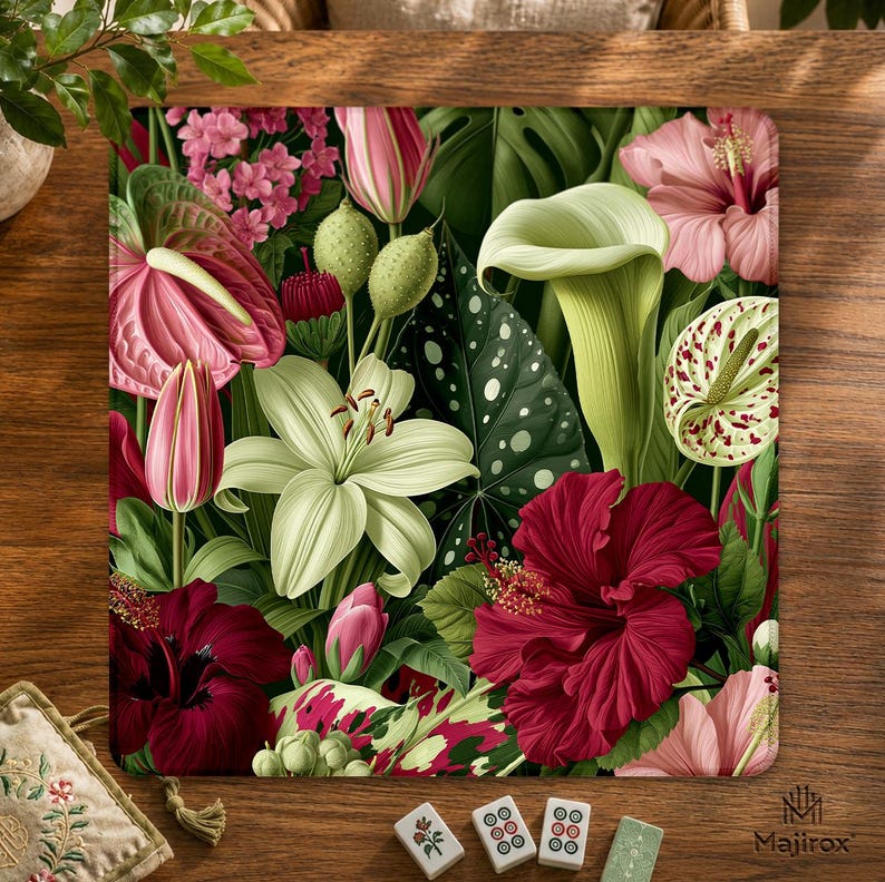 May include: A rectangular mouse pad featuring a dense botanical print of pink hibiscus, white lilies, green calla lilies, and dark red flowers. The design includes large variegated leaves with white spots and the text Majirox in the bottom corner.