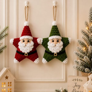 May include: Two star-shaped ornaments crocheted with yarn. One is red and one is green, both featuring a white beard, mustache, hat trim, and cuffs. Each has a black belt with a gold buckle, black eyes, and a tan nose, suspended by a tan rope loop.
