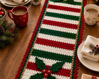 May include: A rectangular crochet table runner featuring alternating horizontal stripes of red, white, and dark green. The runner is bordered by a scalloped red edge and accented with two large, three-dimensional green holly leaf and red berry motifs.