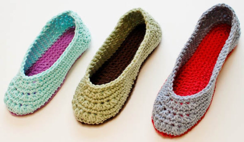 May include: Three pairs of crocheted slippers in different colors. The slippers are made with a soft yarn and have a comfortable fit. The colors are light blue, green, and gray.