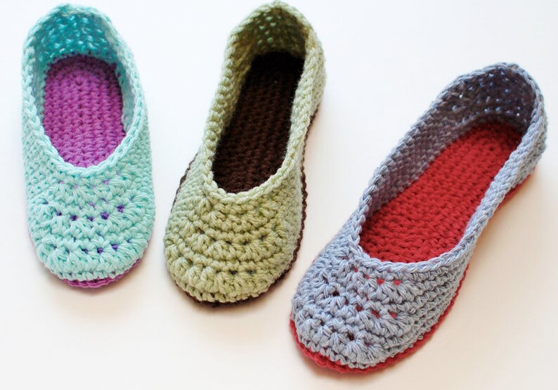 May include: Three pairs of crocheted slippers in different colors. The slippers are made with a soft yarn and have a comfortable fit. The colors are light blue, green, and gray.