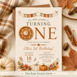 May include: A cream-colored birthday invitation card featuring a pumpkin pie illustration replacing the letter O in the word ONE. The text reads Our little pumpkin is TURNING ONE, Ella's 1st Birthday, Saturday October 18 2025, and event details.