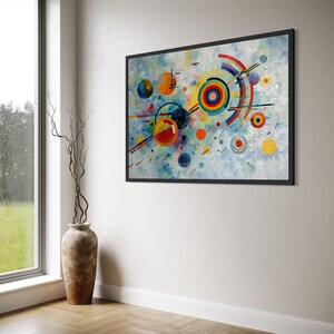 Puede incluir: Una pieza de arte mural rectangular en un marco negro que presenta una composición abstracta de círculos concéntricos coloridos, líneas que se cruzan y formas geométricas sobre un fondo pintado en azul claro y blanco texturizado.