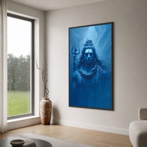 May include: A rectangular wall art print featuring a monochromatic blue portrait of the deity Shiva. The figure has long hair, a trident positioned to the left, and is adorned with necklaces. The artwork is enclosed in a thin black frame.