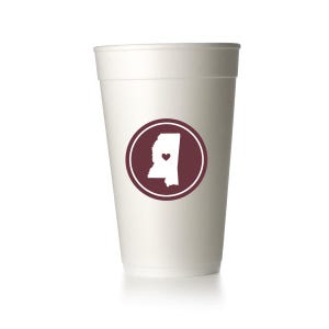 May include: White foam cup with a maroon circle containing a white outline of the state of Mississippi with a small red heart in the center.