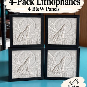 May include: A 4-pack of square lithophane panels in black frames, each featuring a relief carving of a wolf howling at a full moon above a mountain landscape. The text 4-Pack Lithophanes 4 B&W Panels and Stock or Custom Designs is visible.