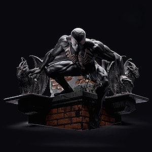 May include: A black and white statue of a superhero figure in a crouching pose, with a white spider-like design on the chest. The figure is positioned on a brick structure, flanked by two gargoyle statues, all against a dark background.