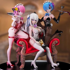 May include: A detailed figurine set featuring three anime-style figures in maid outfits. The figures are posed on a red ornate chair, each holding a tray. The figures have pink, white, and blue hair, and wear black and red outfits.