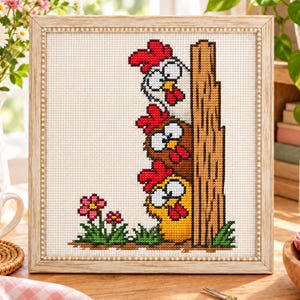 May include: A framed cross-stitch embroidery featuring three cartoon chickens stacked vertically behind a brown wooden fence post. The chickens are white, brown, and yellow with red combs and beaks. Two small pink flowers grow in green grass.