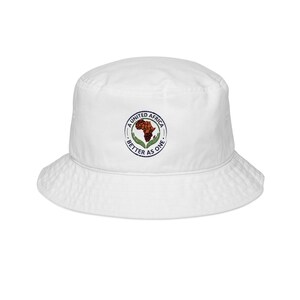 May include: A white bucket hat featuring a circular embroidered emblem on the front. The design displays a brown map of Africa held by two green hands, surrounded by the text A UNITED AFRICA BETTER AS ONE in a dark blue circular border.