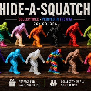 May include: A collection of twelve small, textured Bigfoot figurines in various solid and multi-colored plastic finishes, including green, pink, orange, black, red, purple, blue, white, brown, and a rainbow pattern, arranged on a dark wooden surface.