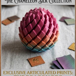 May include: A multi-colored, articulated dragon egg with a gradient of pink, orange, and blue hues. The egg is surrounded by small color swatches and a tag that reads "THE TWISTY EGG". The text "THE CHAMELEON SILK COLLECTION" and "EXCLUSIVE ARTICULATED PRINTS: THE DRAGON EGG" are also visible.