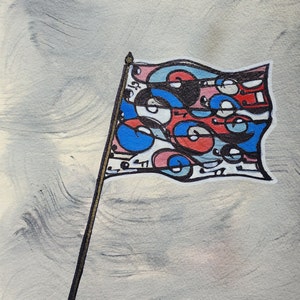 May include: A colorful abstract flag with blue, red, and pink swirls and circles on a white background. The flag is attached to a gold pole against a gray background.