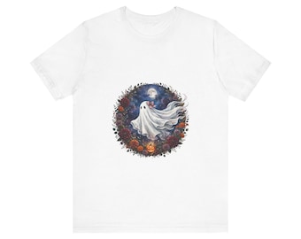 May include: A white short-sleeved t-shirt featuring a circular graphic print. The design depicts a white ghost with a small red bow, surrounded by a wreath of dark autumn flowers, foliage, a glowing orange jack-o'-lantern, and a full moon.