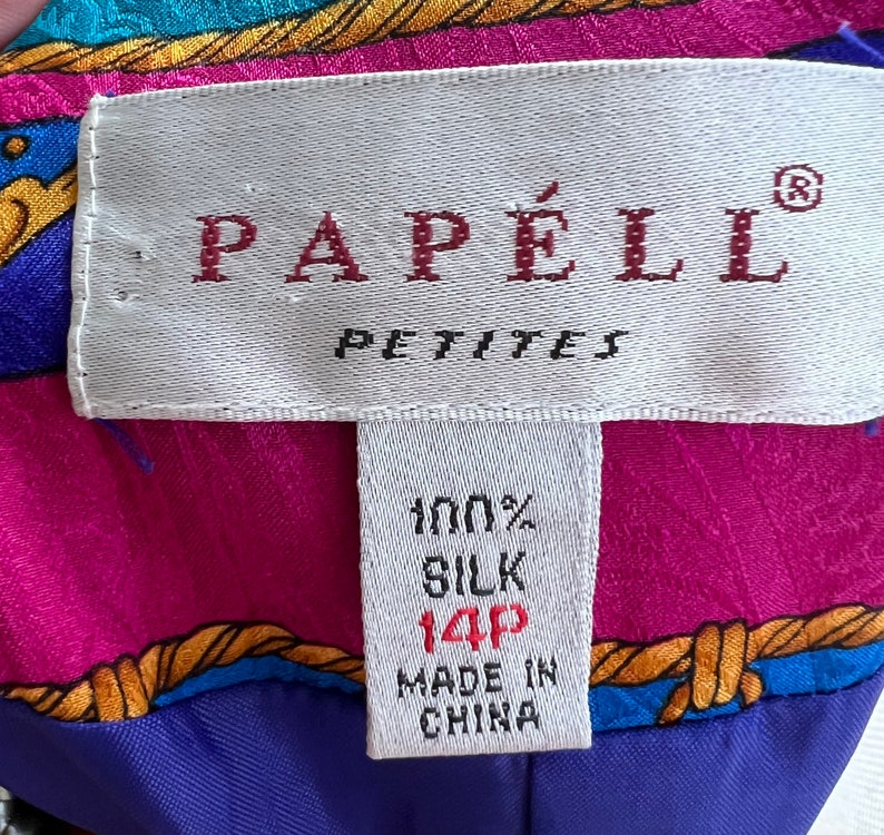 May include: A white tag with red text that reads "Papell Petites" and a smaller white tag with black text that reads "100% Silk 14P Made in China".