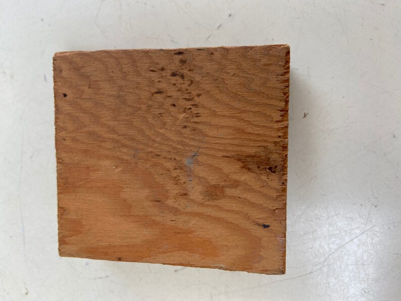 May include: A piece of unfinished, light brown wood with a natural wood grain pattern.
