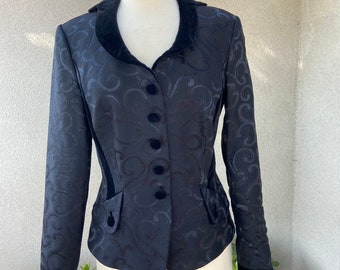 May include: A black blazer with a velvet collar and a swirl pattern. The blazer has a fitted silhouette and a button-up front.