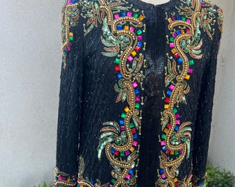 May include: A black sequined jacket with colorful beaded embroidery. The embroidery features a floral design with gold accents.