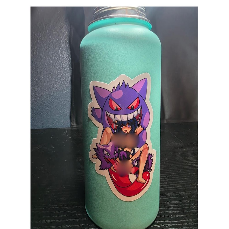 May include: A teal water bottle with a sticker featuring a purple Gengar character with a red mouth and eyes, and a graphic of a person. The sticker is placed on the front of the bottle.