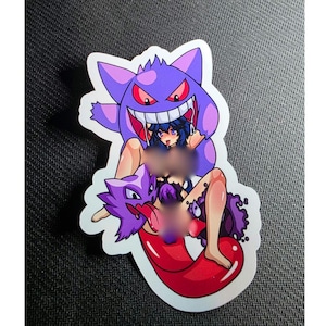 May include: A sticker featuring a purple cartoon character with a large grin and red eyes, with a woman in the middle. The sticker has a white border and is on a dark surface.
