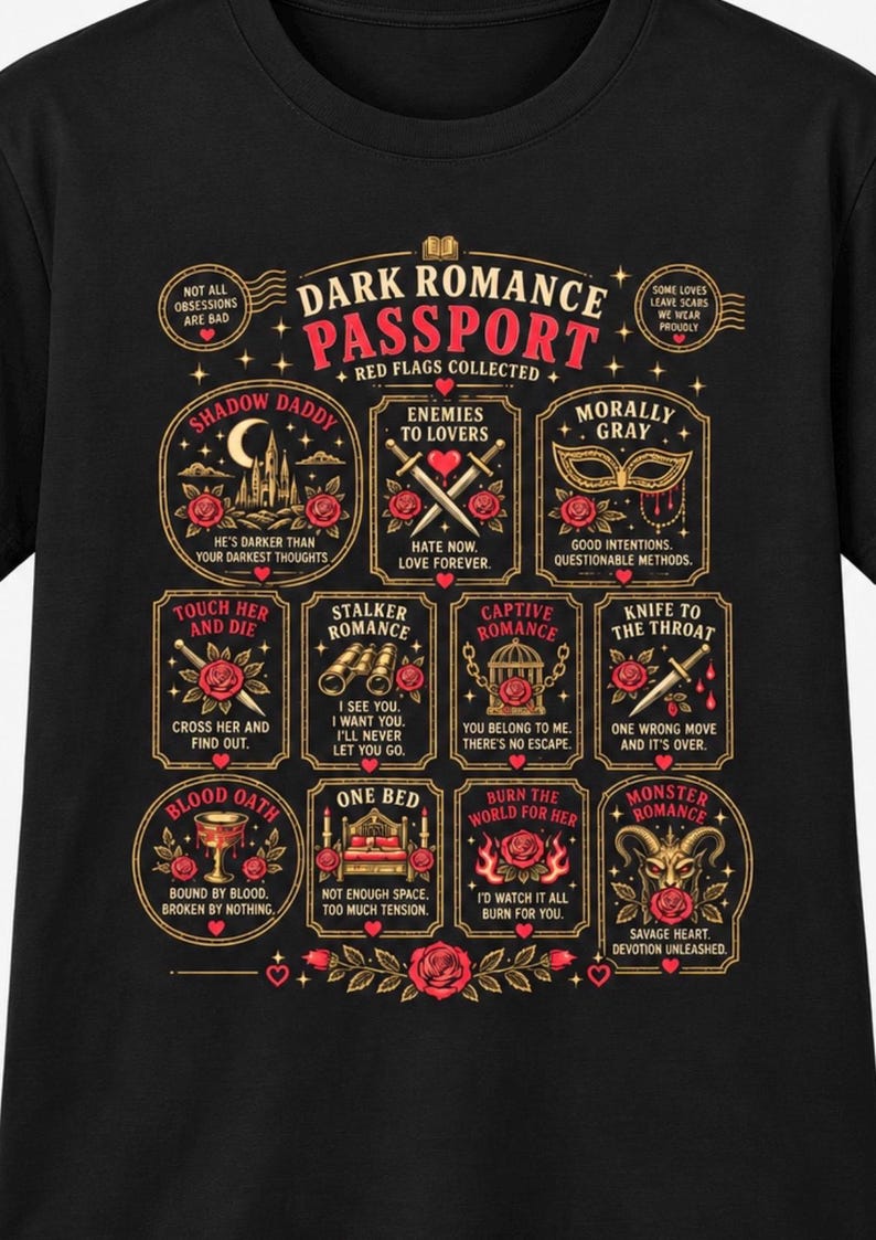 May include: A black t-shirt featuring a graphic titled Dark Romance Passport with Red Flags Collected. It displays twelve rectangular and circular frames containing illustrations of roses, swords, masks, cages, and hearts with text captions like Shadow Daddy, Enemies to Lovers, and Morally Gray.