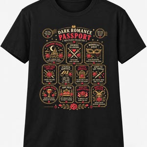 May include: A black short-sleeve t-shirt featuring a graphic titled Dark Romance Passport. The design includes twelve rectangular and circular frames with red roses, swords, masks, and text such as Shadow Daddy, Enemies to Lovers, and Morally Gray.
