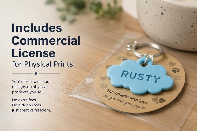 May include: A light blue cloud-shaped pet tag with the name RUSTY embossed on the front, attached to a silver metal keyring. The tag is mounted on a circular brown card featuring paw print and heart icons, enclosed in a clear plastic sleeve.