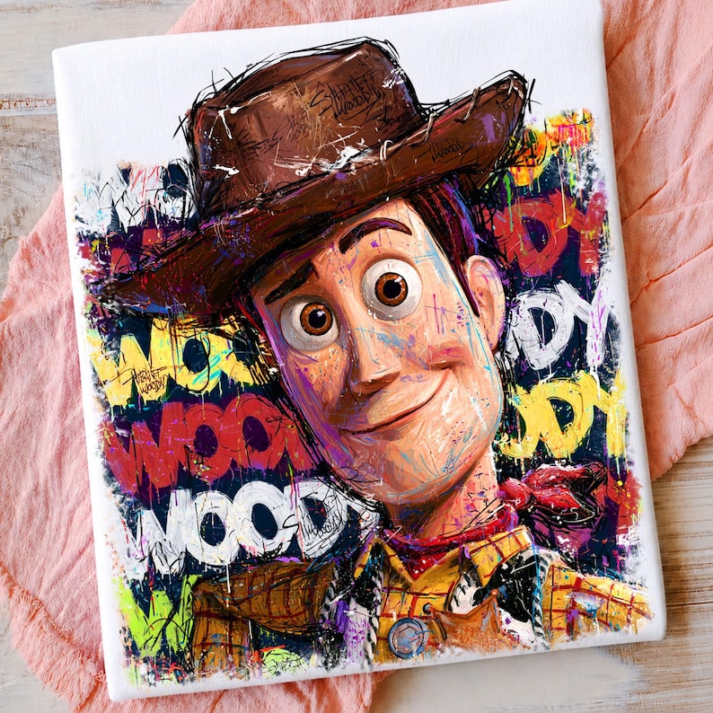 May include: A canvas print featuring a stylized portrait of the character Woody wearing a brown cowboy hat. The background is filled with vibrant, multi-colored graffiti-style paint splatters and the repeated text "WOODY" in various fonts.