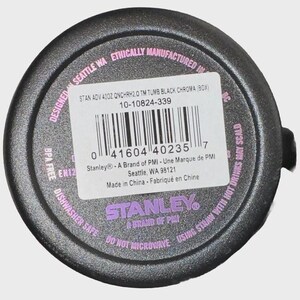 May include: A black Stanley tumbler bottom with a product label. The label includes the text "STAN ADV 40OZ QNCHRH2.0 TM TUMB BLACK CHROMA (BOX)" and a barcode. The tumbler is dishwasher safe and BPA free.