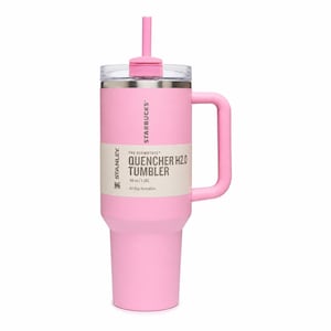 May include: A light pink Stanley Starbucks Quencher H2.0 tumbler with a 40 oz capacity. The cup features a matching pink handle, a clear lid, and a pink straw. A beige product label is wrapped around the center with the text Starbucks and Stanley.