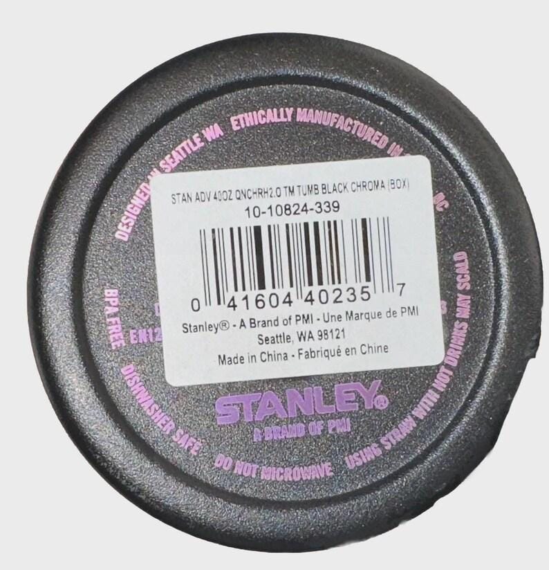 May include: Black tumbler base with a white label and barcode. The label includes the text "STAN ADV 40OZ QNCHRH2.0 TM TUMB BLACK CHROMA (BOX)" and "STANLEY A BRAND OF PMI". The base is dishwasher safe.