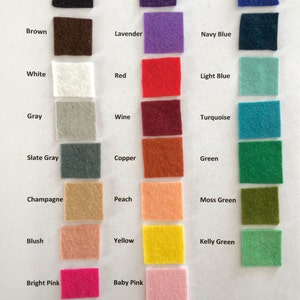 May include: A color chart featuring small, square felt swatches in various colors. The chart includes colors like black, brown, white, gray, red, and green, with each color labeled. The image is well-lit, showcasing the texture and hue of each felt square.