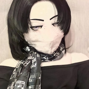 May include: A black off-the-shoulder top with a black and white musical note scarf. The scarf is draped around the neck. The image also shows a black wig and a face mask.