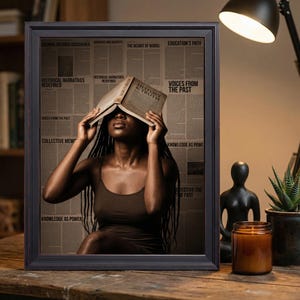 May include: A framed wall art print featuring a person with long dark braids holding an open book titled History and Truth over their face. The background consists of a collage of newspaper-style text with headlines like Voices from the Past.