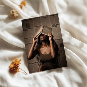 May include: A rectangular print featuring a person in a brown tank top holding an open book titled History & Truth over their face. The background is a collage of newspaper columns with text including Voices From The Past and Knowledge As Power.