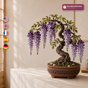 May include: A crocheted wisteria bonsai tree with a twisted brown trunk, green leaves, and cascading purple and lavender flower clusters. The tree is planted in a round, brown crocheted pot with a dark geometric pattern and small feet. KundiCollection.