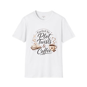 May include: White t-shirt with the text "Fueled by Plot Twists & Coffee" in a whimsical design. The graphic includes an open book, coffee cup, and decorative elements. A casual, comfortable tee.