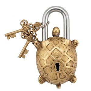 May include: A brass-colored metal padlock shaped like a turtle with a textured shell and a keyhole in the center. A silver-toned metal shackle extends from the top of the turtle shell. Two ornate brass-colored keys are attached to the shackle.