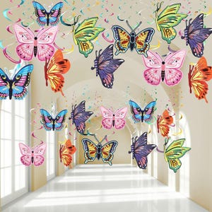 May include: A collection of hanging butterfly decorations featuring various colors including pink, blue, yellow, orange, and purple. Each butterfly is attached to a colorful spiral swirl streamer, creating a multi-layered display of insects.