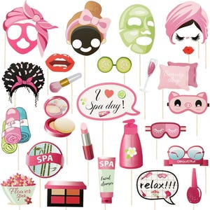 May include: A collection of spa-themed photo booth props on sticks, including face masks, cucumber slices, makeup brushes, lipstick, nail polish, a pink pillow with text Beauty sleep, and speech bubbles with text I love Spa day and relax!!!