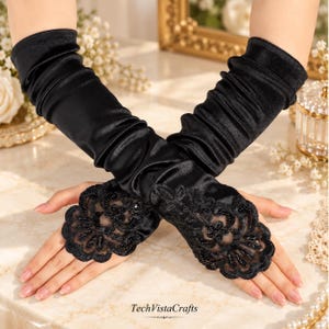 May include: A pair of black elbow-length gloves made of a smooth, satin-like fabric with gathered detailing along the arms. The hand portion features intricate black lace overlays adorned with small black beads and sequins. The text TechVistaCrafts is visible at the bottom.