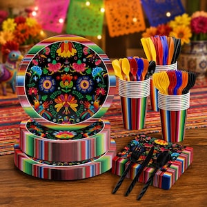 May include: A set of disposable party supplies featuring a black background with colorful floral and bird patterns on plates and napkins, paired with striped cups and multi-colored plastic forks, knives, and spoons for festive table settings.