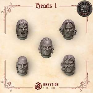 Peut inclure: Cinq têtes miniatures grises avec diverses expressions, dont la colère et la détermination. Le texte "Heads 1" est en haut, et le logo "GREYTIDE STUDIO" est en bas. Un emblème circulaire est dans le coin supérieur droit.