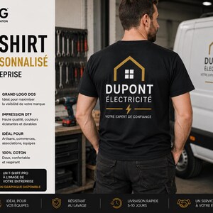 May include: A black short-sleeved t-shirt featuring a gold and white graphic on the back. The graphic displays a house outline, the text DUPONT &Eacute;LECTRICIT&Eacute;, a lightning bolt icon, and the text VOTRE EXPERT DE CONFIANCE in white and gold.