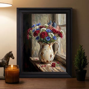 May include: A framed painting depicts a still life of flowers in a rustic white pitcher. The flowers are red, white, and blue, with small American flags. The pitcher sits on a wooden windowsill, with a candle and a small horse statue in the foreground.