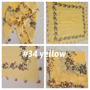 May include: Yellow square scarf with floral border and corner designs. The scarf has a fringe of small, decorative tassels. The text "#34 yellow" is visible in the image.