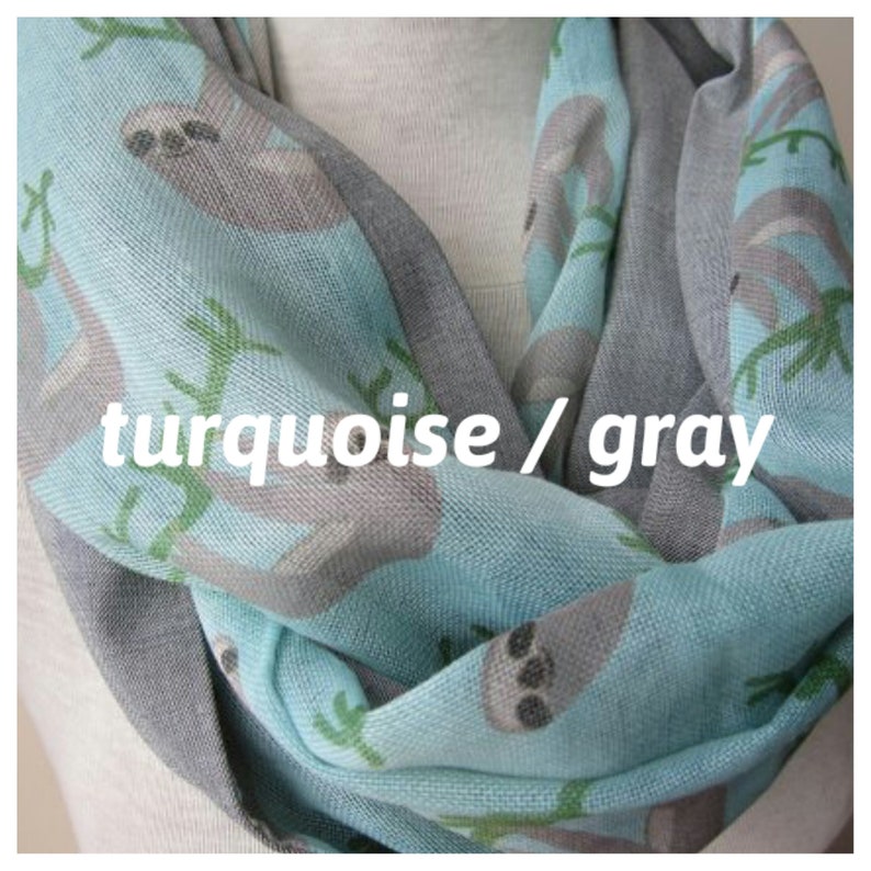 May include: Turquoise and gray infinity scarf with a sloth print. The scarf is made of a soft, lightweight fabric and is perfect for adding a touch of whimsy to any outfit.