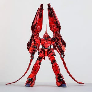 May include: A red robot action figure with large, angular wings and long, segmented tail-like appendages. The figure has a detailed design with a metallic finish, standing on a white surface. The robot's head features a prominent horn.